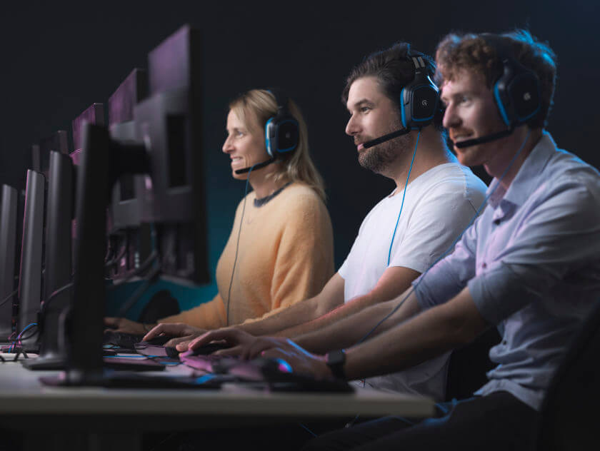 Games Students in Front of Computers with Headsets